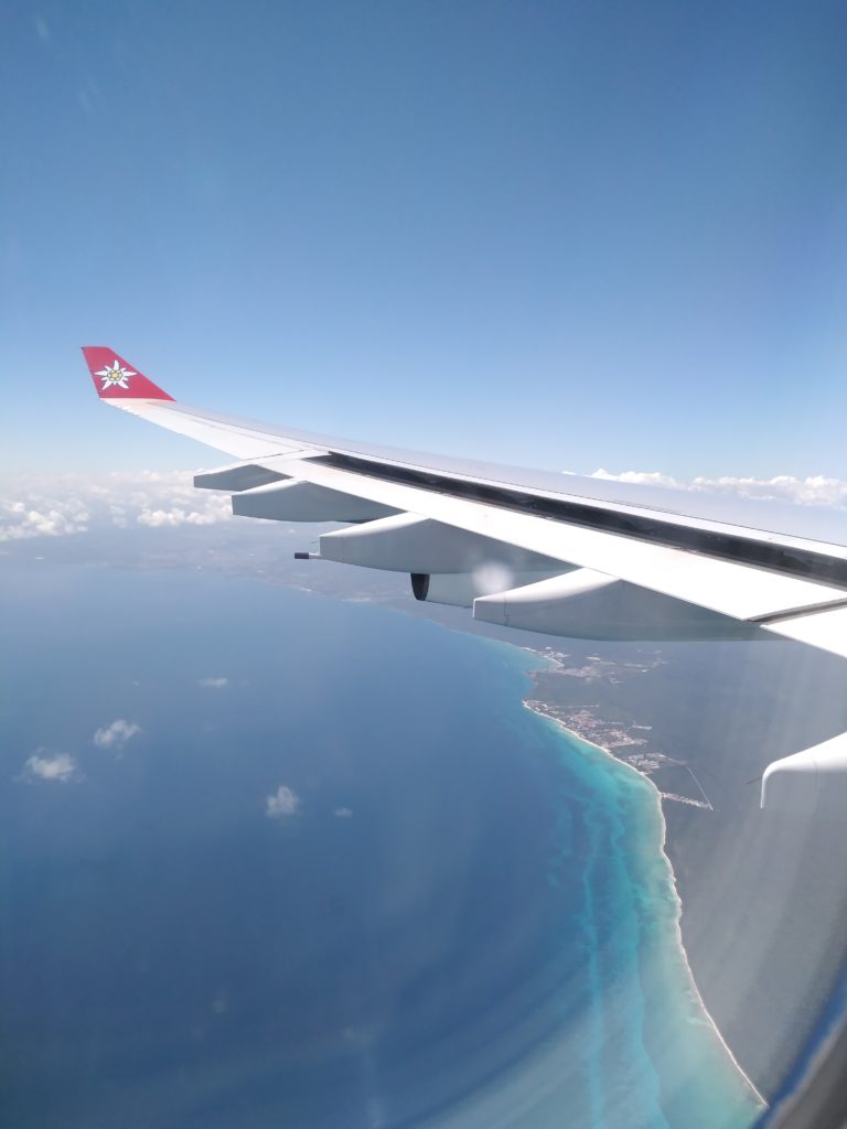 Flügel eines Flugzeugs und Sicht auf Inseln